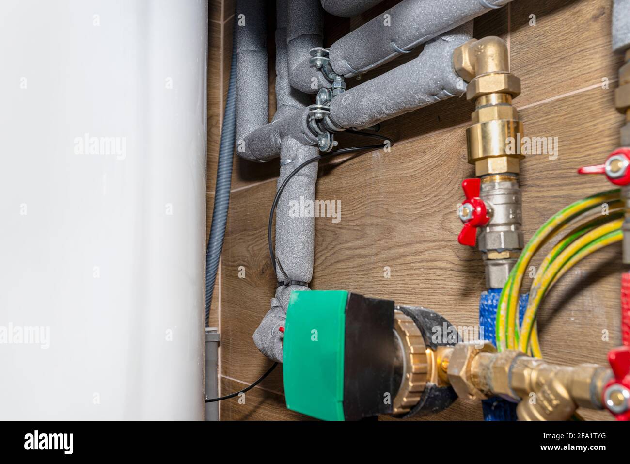 Natural gas valves and pipes in a modern home boiler room with ceramic