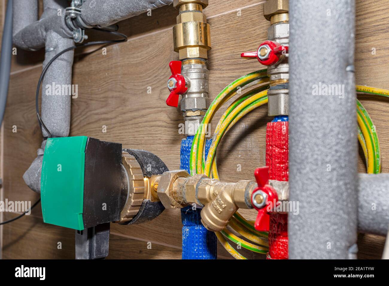 Natural gas valves and pipes in a modern home boiler room with ceramic