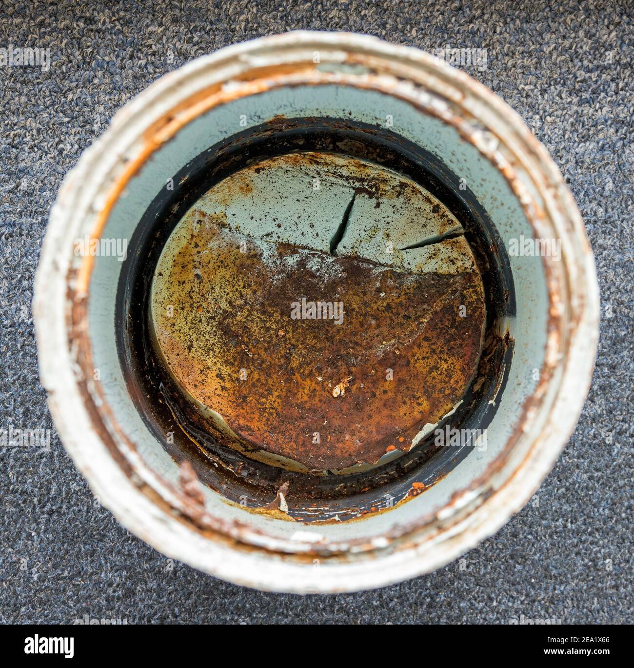 Old dried paint in the bottom of a paint can. Paint is very dirty and