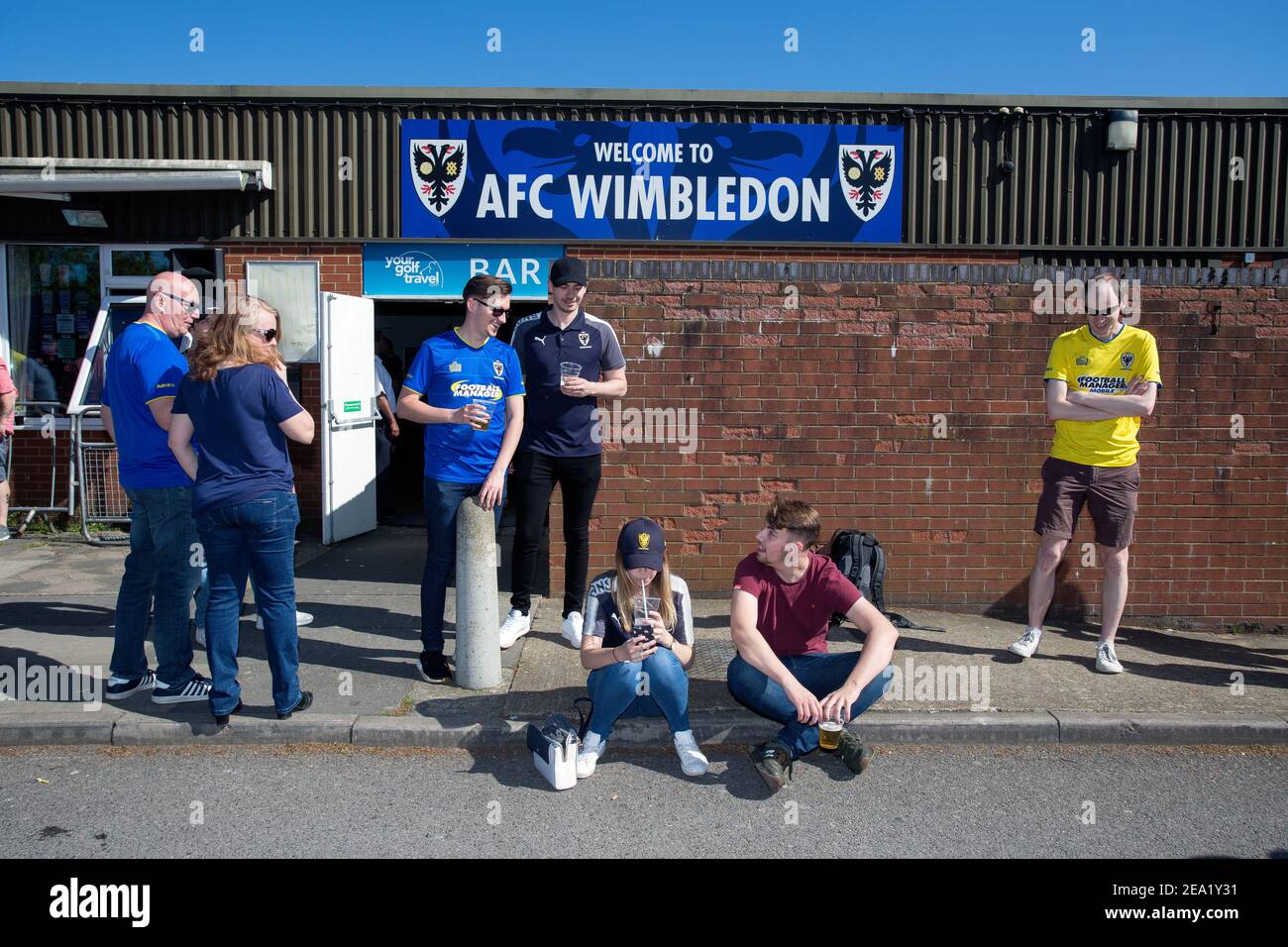 Football supporters waiting in front of AFC Wimbledon football club, England. Stock Photo