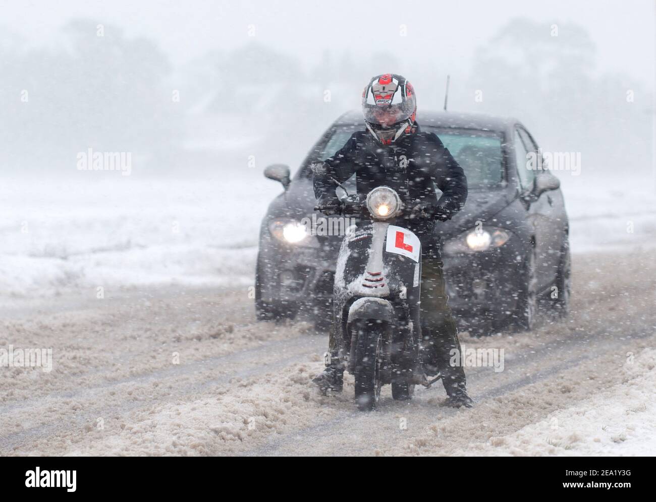 Vehicles make their way through snow and blizzard conditions near Kirby Cross in Essex, with heavy snow set to bring disruption to south-east England and East Anglia as bitterly cold winds grip much of the nation. Picture date: Sunday February 7, 2021. Stock Photo