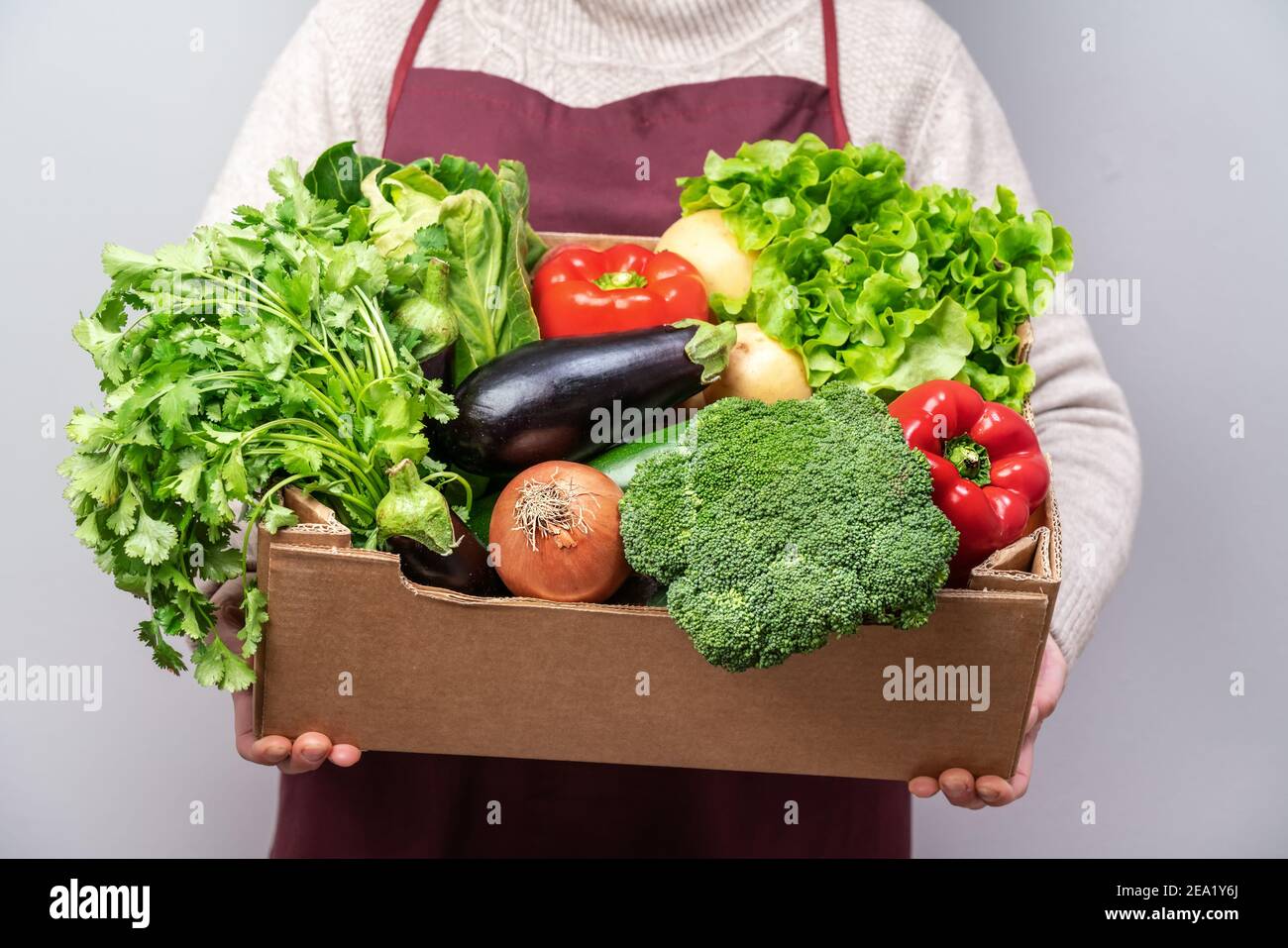 Middle aged woman volunteer delivers food and vegetables to people in