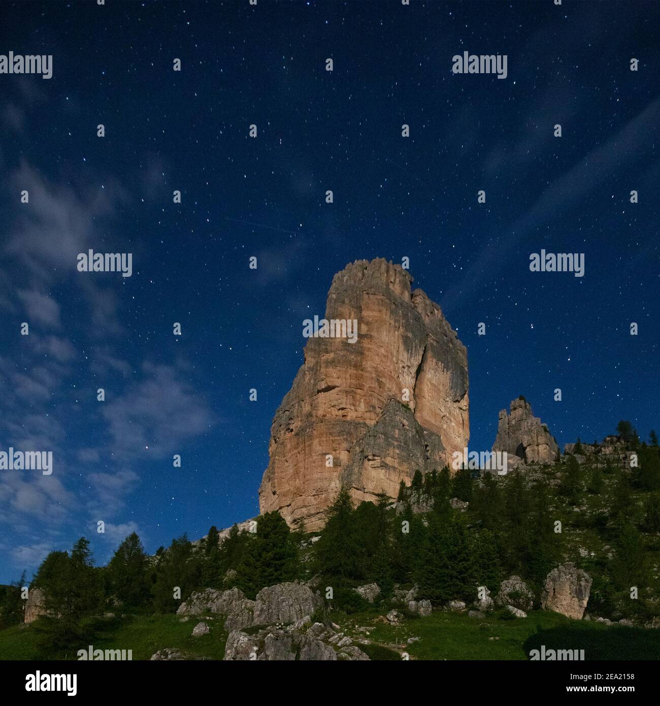 Night landscape and starry sky. Cinque Torri mountain peaks. The Ampezzo Dolomites. Italian Alps. Europe. Stock Photo