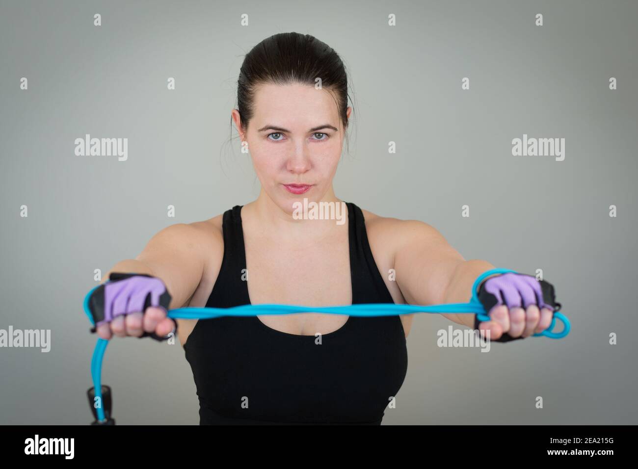 beautiful white caucasian girl in a black T-shirt on fitness holding a ...