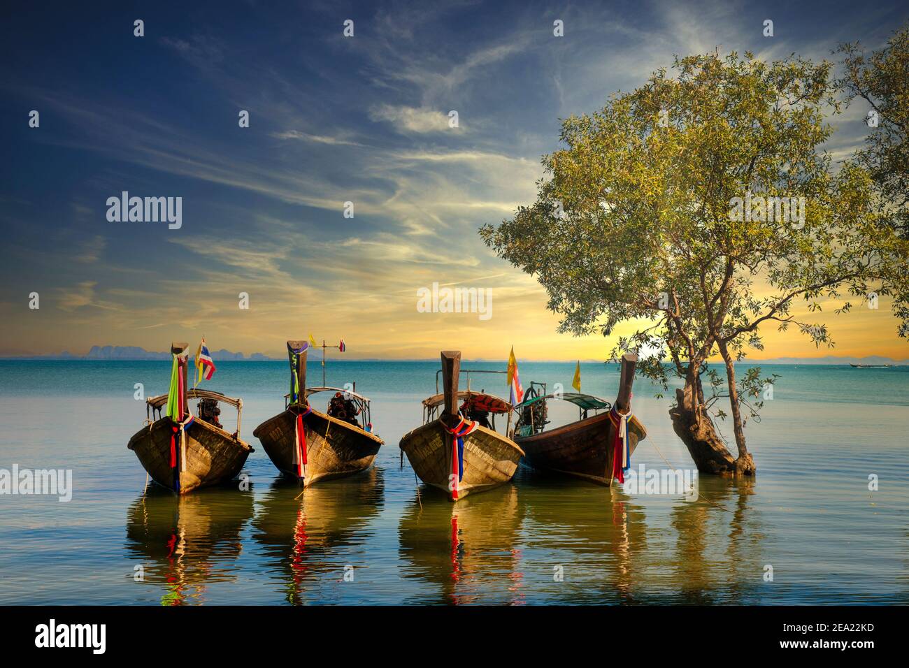 Four long-tail boats moored on the Railay Beach in Krabi, Thailand. These boats are the traditional form of water transport in Krabi Stock Photo
