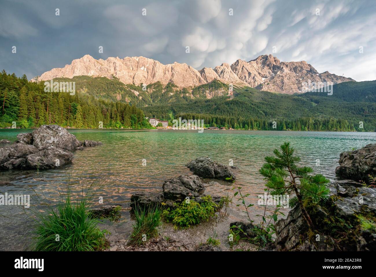 Rocks on the shore, Lake Eibsee lake in front of Zugspitze massif with ...