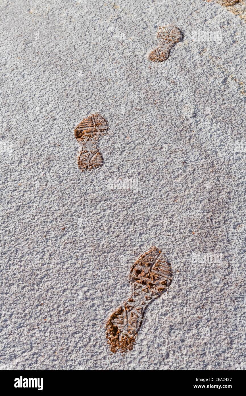Footsteps in the salt crust at the shores of Ounianga kebir part of the the Unesco sight Ounianga lakes, northern Chad, Africa Stock Photo