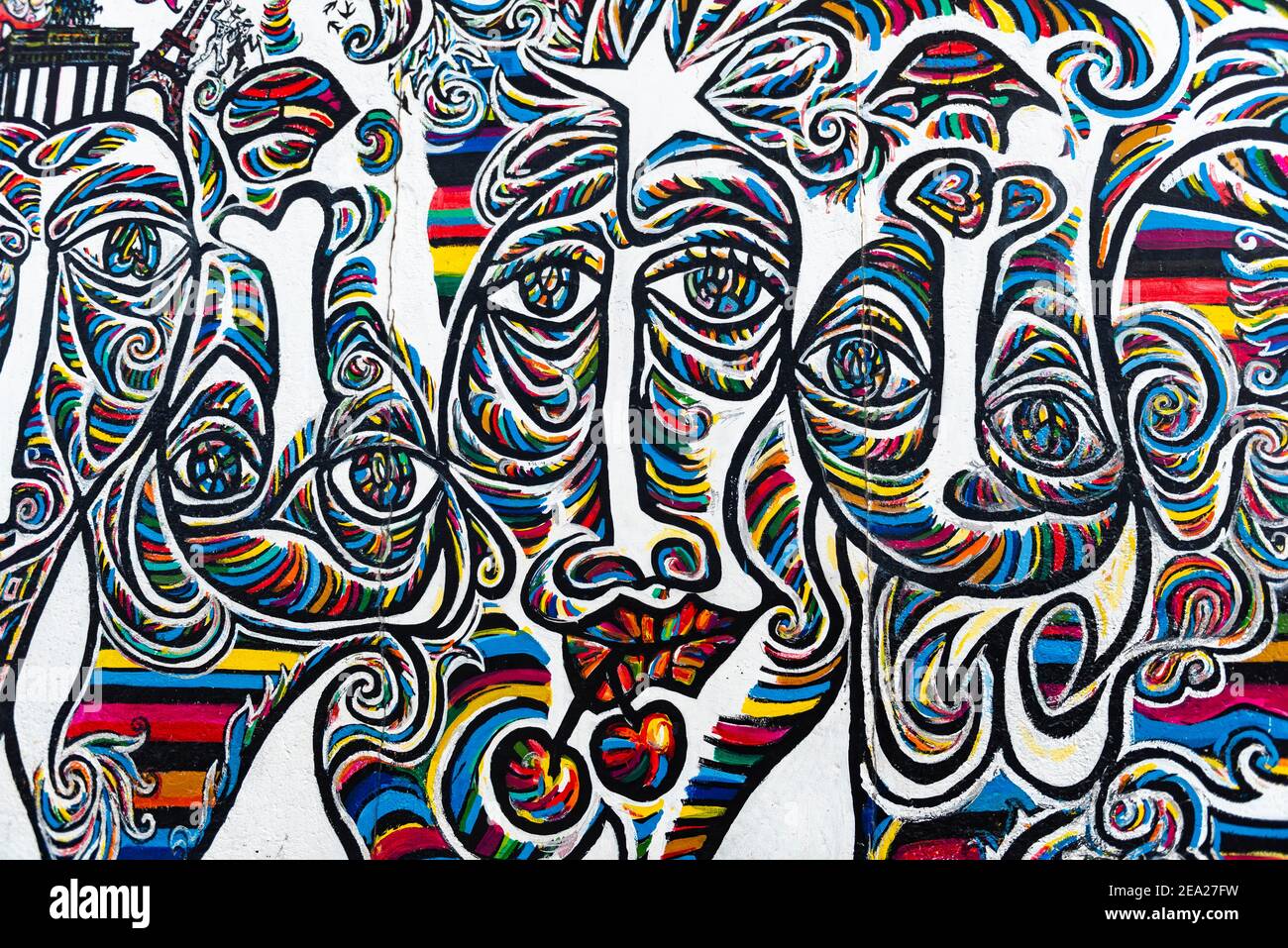 Graffiti We are one people, mural with colorful faces, artist Shamil Gimayev, East Side Gallery, Friedrichshain, Berlin, Germany Stock Photo