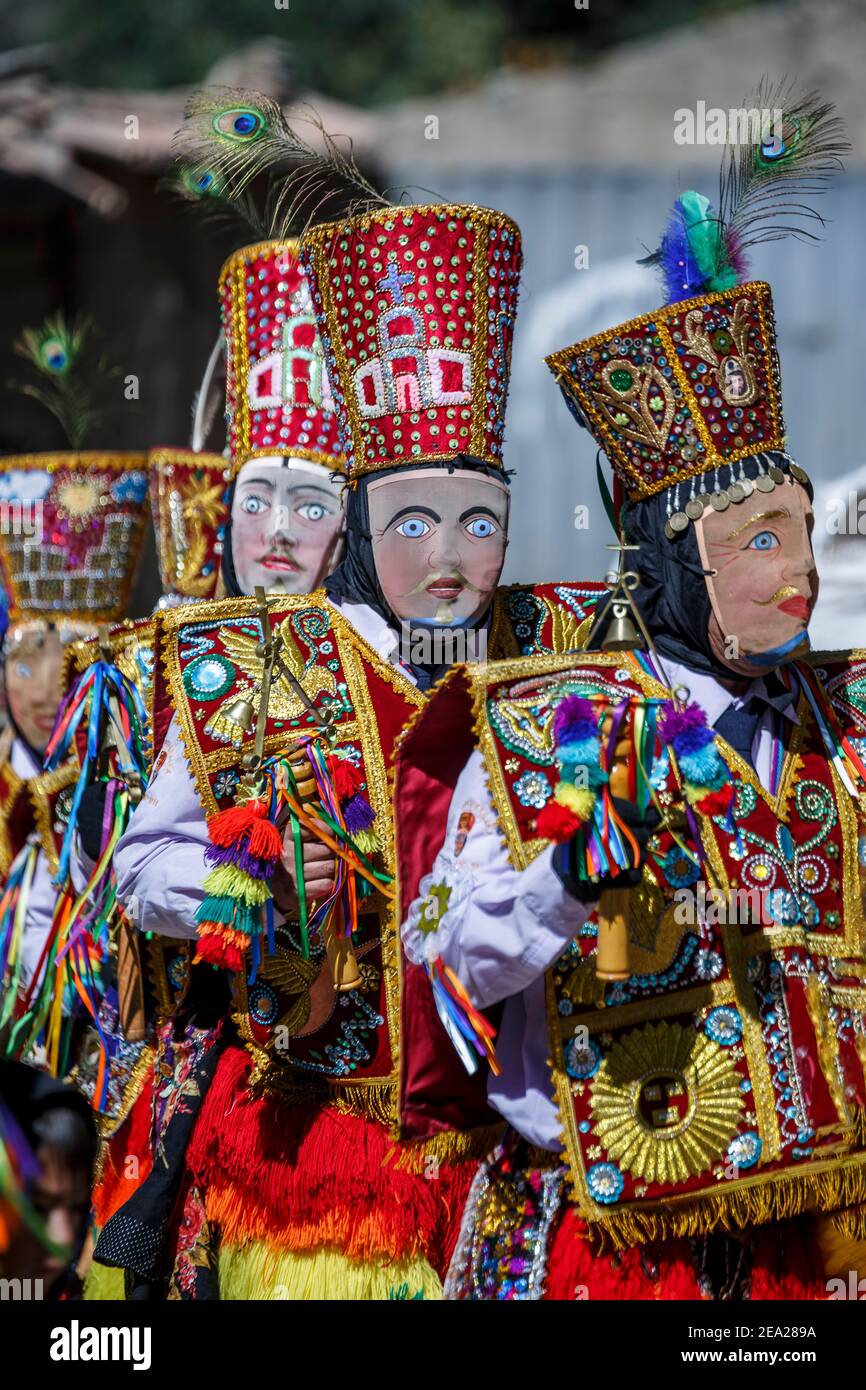 Participants wearing colorful costumes during religious procession, Ollantaytambo, Cusco, Peru Stock Photo