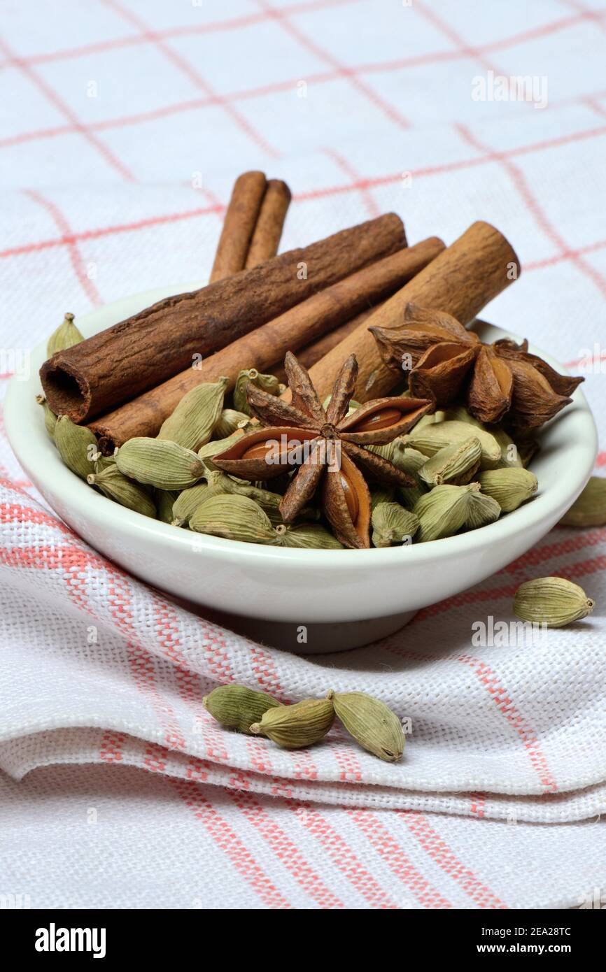 Christmas spices in bowl, cinnamon sticks( Elettaria cardamomum) , star anise ( Illicium verum) Stock Photo