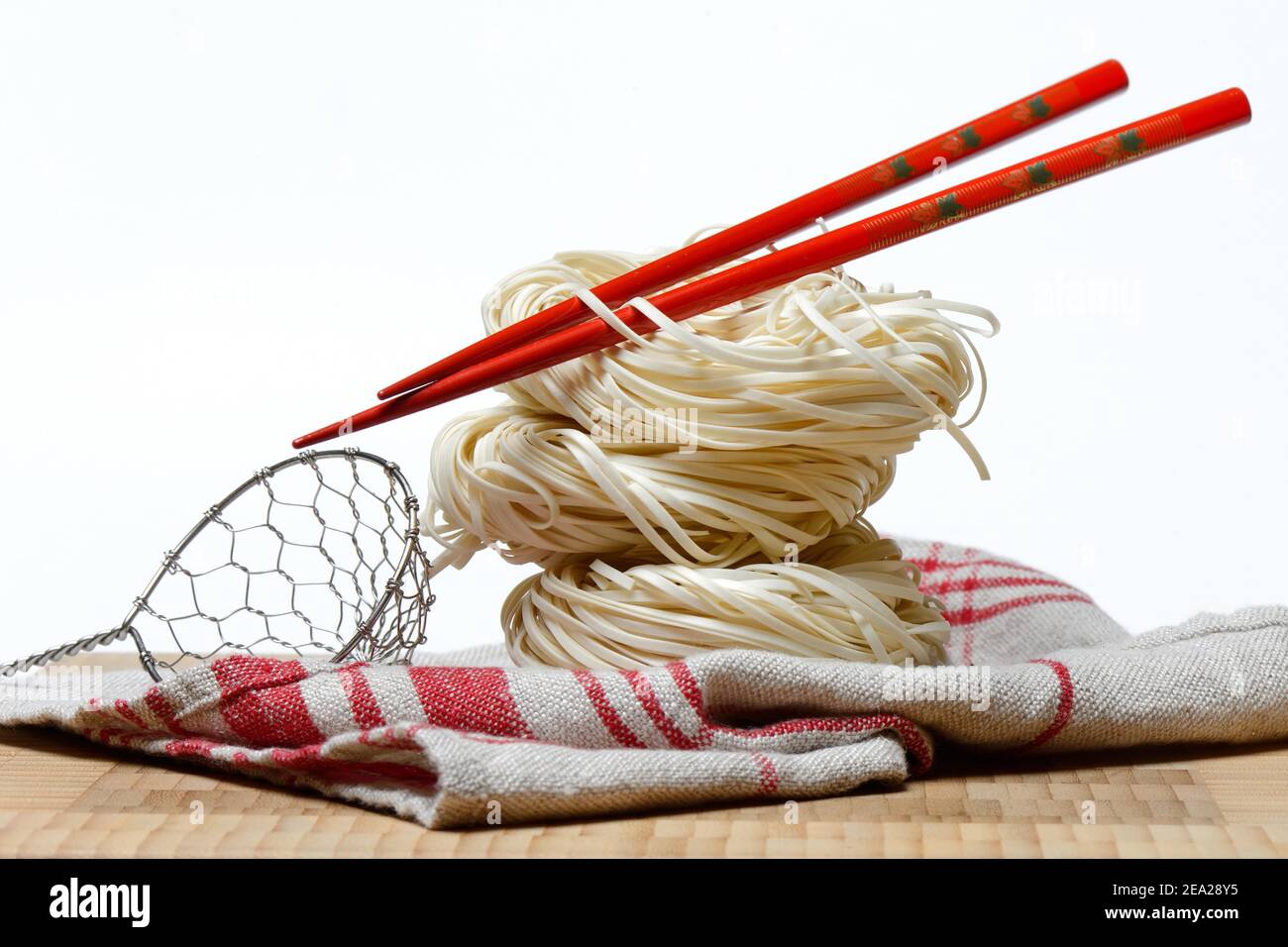 Chinese Yangchun noodles with chopsticks, uncooked, nest noodles Stock Photo Alamy