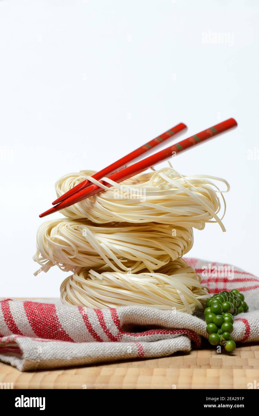 Chinese Yangchun noodles with chopsticks and green pepper, nest noodles Stock Photo Alamy