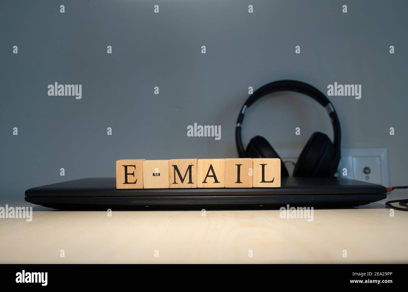 email word written on the background computer and headset concept. Closeup. Stock Photo