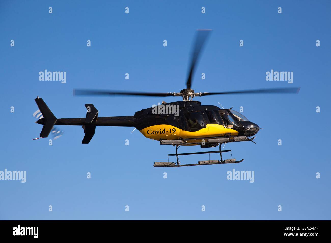 Black and yellow helicopter with the inscription covid19. Helicopter