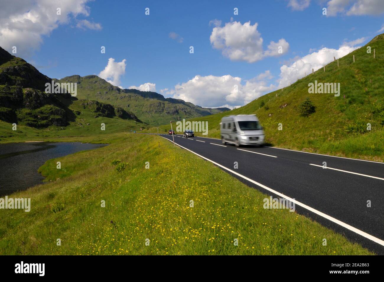 Camper van on scenic road in Scotland. Road A83 in Argyll and Bute. Stock Photo