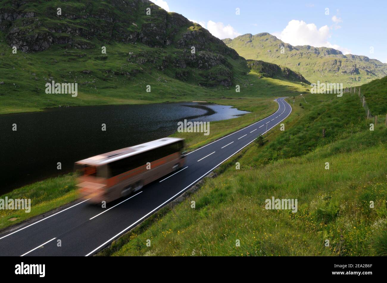 Bus on mountains road in Scotland.Road A83 Argyll and Bute. Stock Photo
