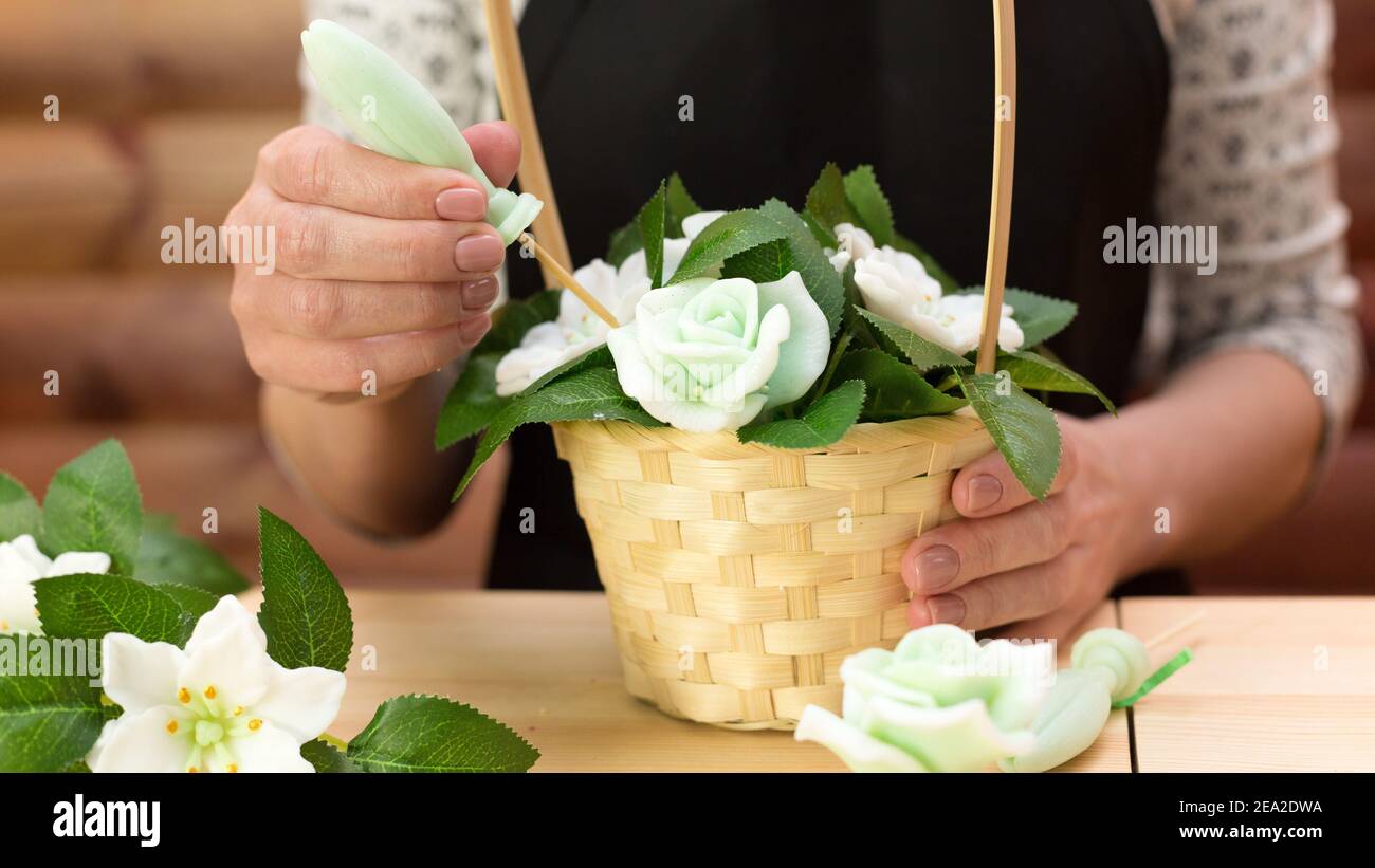 Drawing Up A Flower Arrangement A Woman Collects A Bouquet In A Basket Stock Photo Alamy