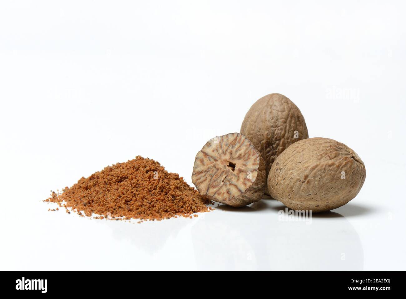 Nutmegs and nutmeg powder, ground Stock Photo