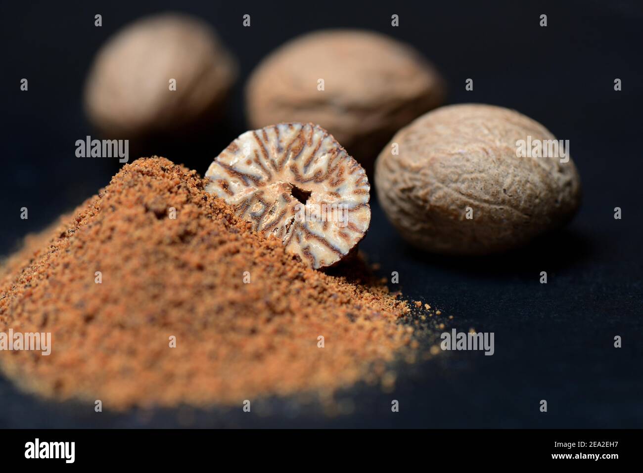 Nutmegs and nutmeg powder, ground, grated Stock Photo Alamy