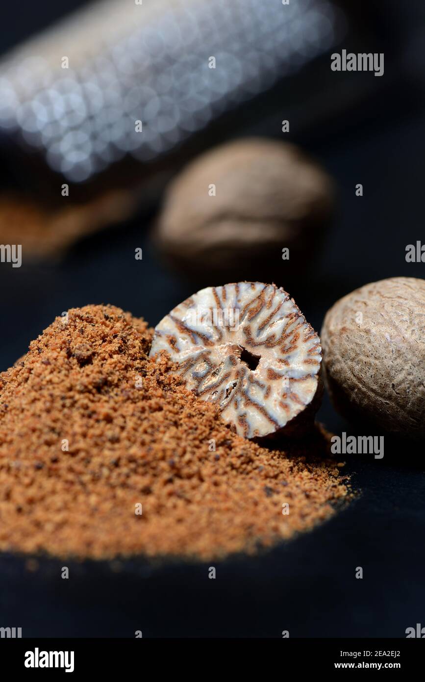 Nutmegs and nutmeg powder, ground, grated Stock Photo Alamy