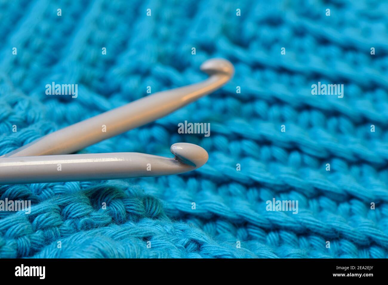 Crochet hooks with potholders Stock Photo