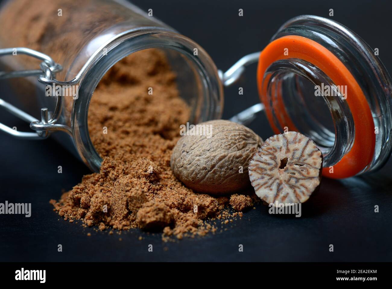 Nutmegs and nutmeg powder in glass containers, ground, grated