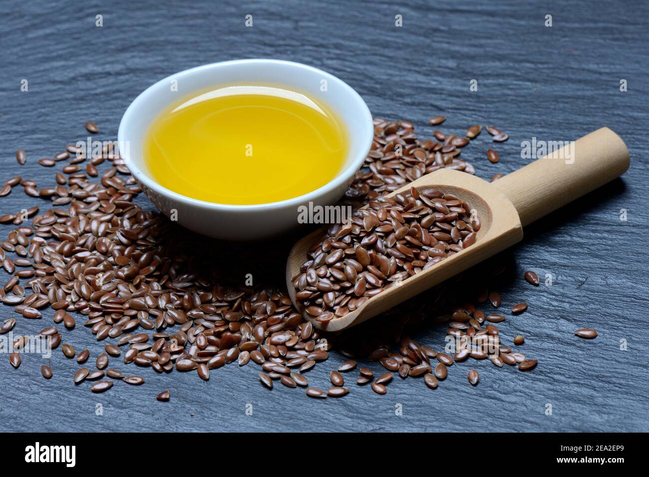 Linseed ( Linum usitatissimum) and linseed oil in small bowls Stock