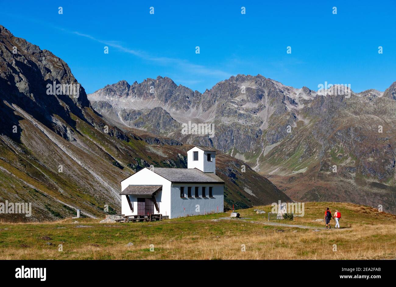 Hiker at the Barbarakapelle, Bielerhoehe, Silvretta High Alpine Road, Vorarlberg, Austria Stock Photo
