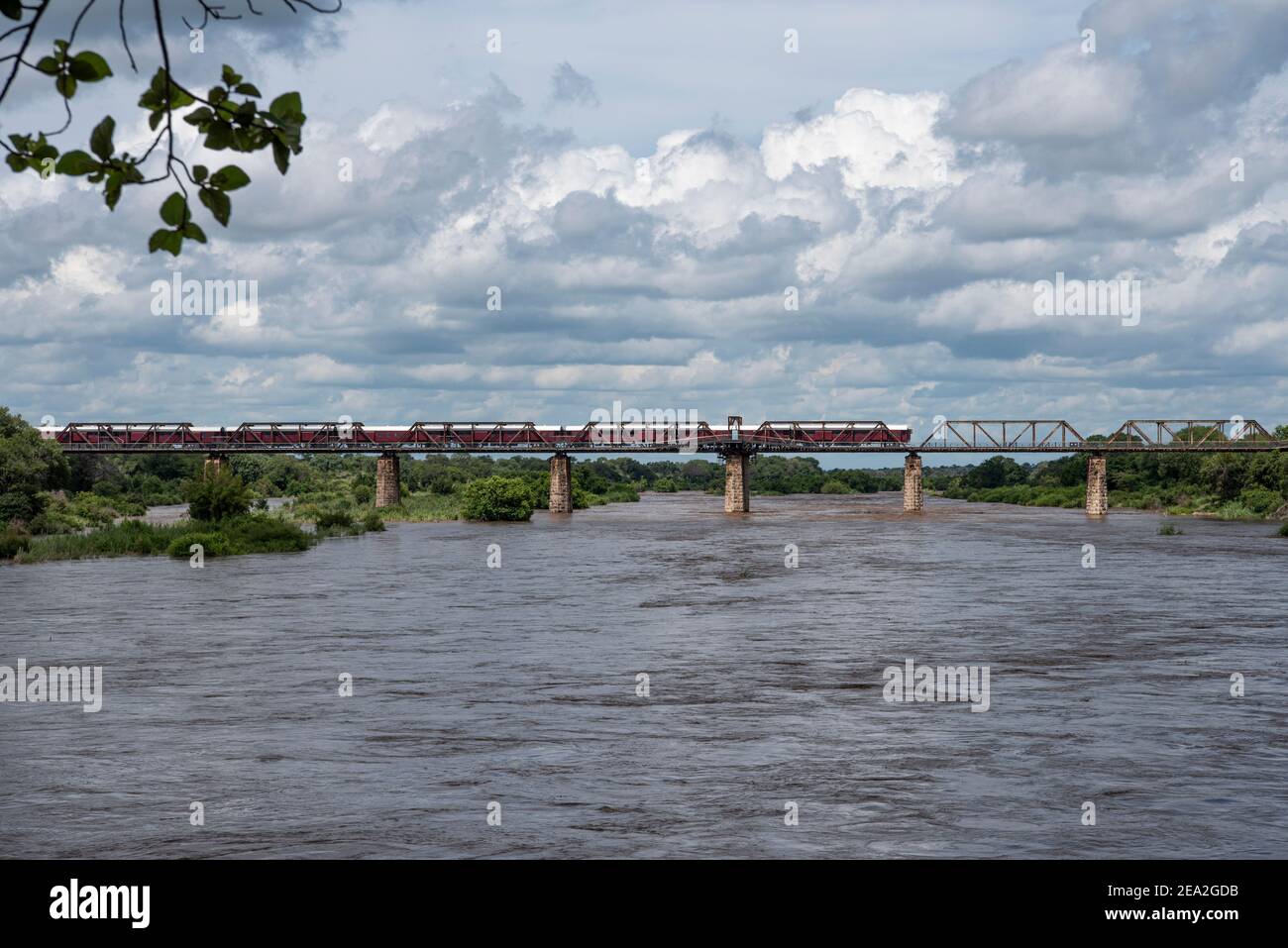 Wide angle of the Sabie River flowing strongly with the Shalati Train Lodge above it on the Selati bridge Stock Photo