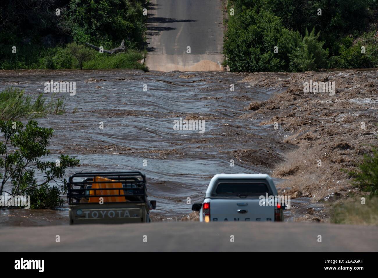 Vehicles not able to drive over the bridge because the bridge is under water Stock Photo