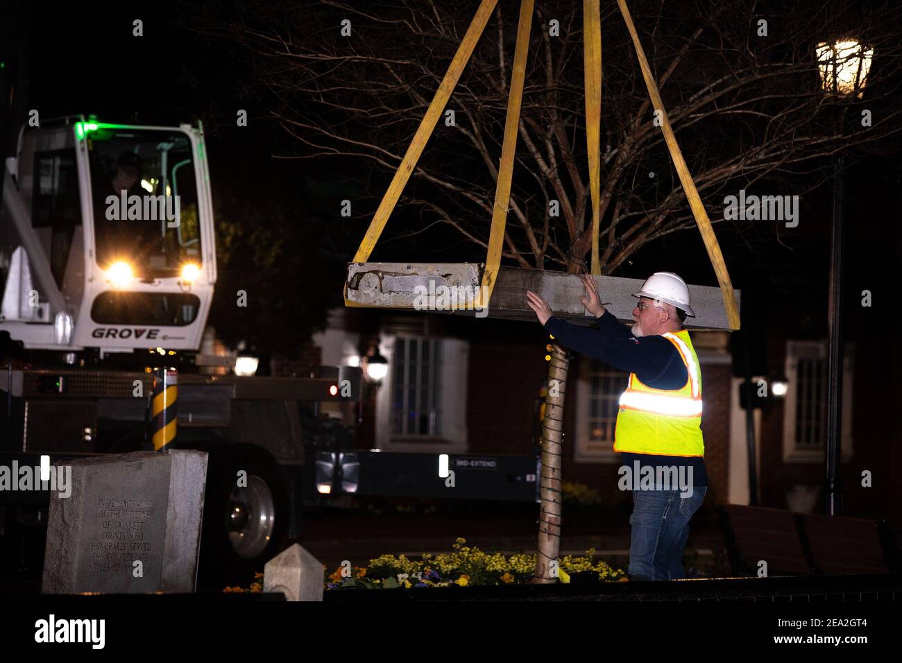 Mart Clamp, right, of Clamp Sandblast in Elberton, Georgia, works with a crew to remove a Confederate monument from its place on the grounds of the Gwinnett Historic Courthouse in Lawrenceville, Georgia, on February 4, 2021. The Gwinnett County Board of Commissioners voted unanimously on January 19 to remove the monument, overturning the decision of their predecessors from almost three decades prior. In 1993, county commissioners gave permission for the monument to be installed at the request of the United Daughters of the Confederacy. (Photo by Casey Sykes/Atlanta Journal-Constitution/TNS/Sip Stock Photo
