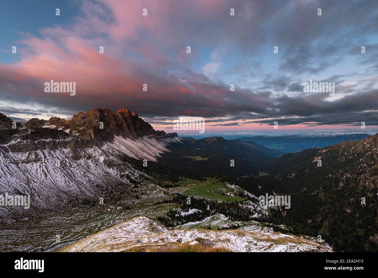 Clouds, cliffs and the peaks of the Puez-Odle mountains in the red twilight at sunrise at the Dolomites, Villnöß valley, Sout Tyrol, Italy Stock Photo