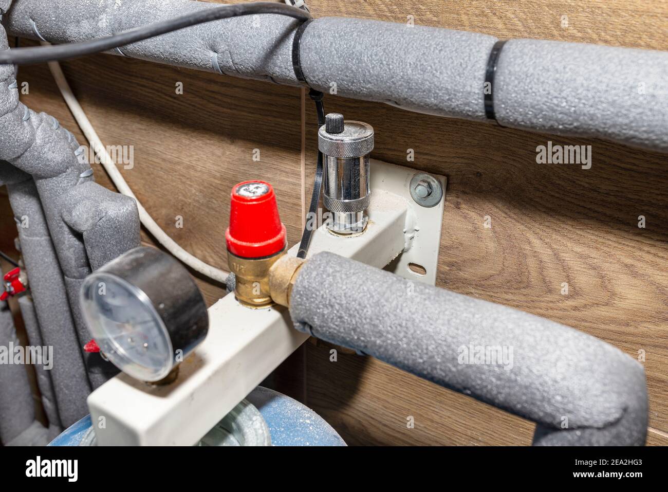 Expansion vessel protecting against pressure in a modern boiler room lined with ceramic tiles