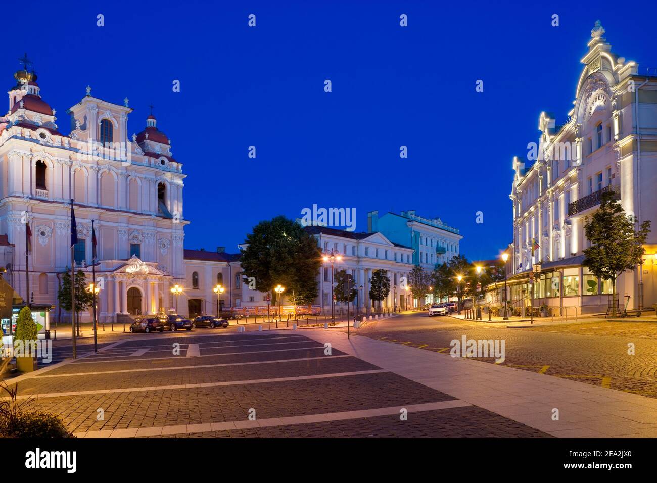 Night view of illuminated church of St. Casimir and Astorija hotel in the Old Town of Vilnius, Lithuania Stock Photo