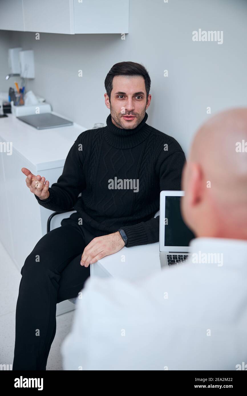 Handsome doctor talking young hi-res stock photography and images - Alamy