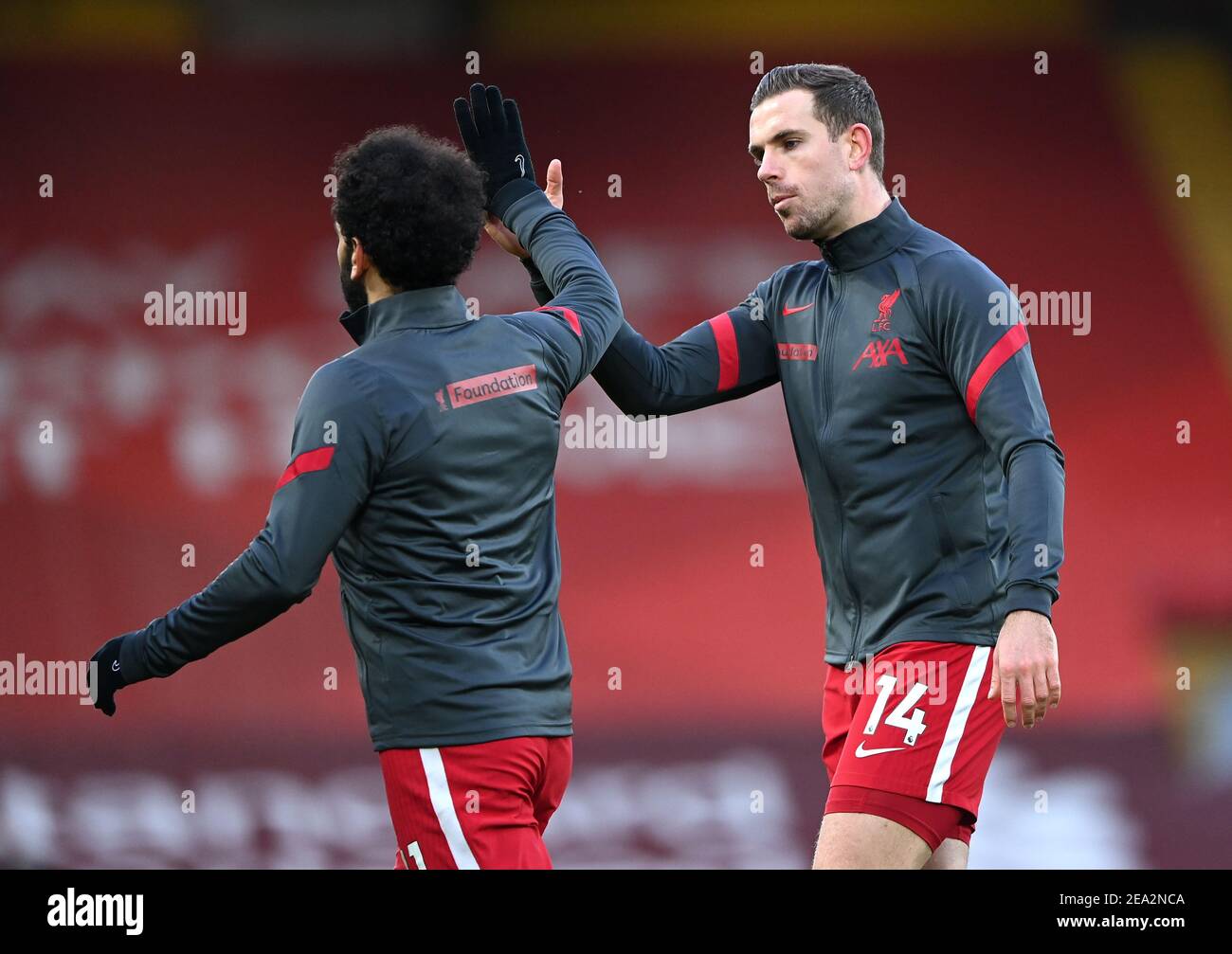 Liverpool's Mohamed Salah (left) greets Liverpool's Jordan Henderson before the Premier League match at Anfield, Liverpool. Picture date: Sunday February 7, 2021. Stock Photo