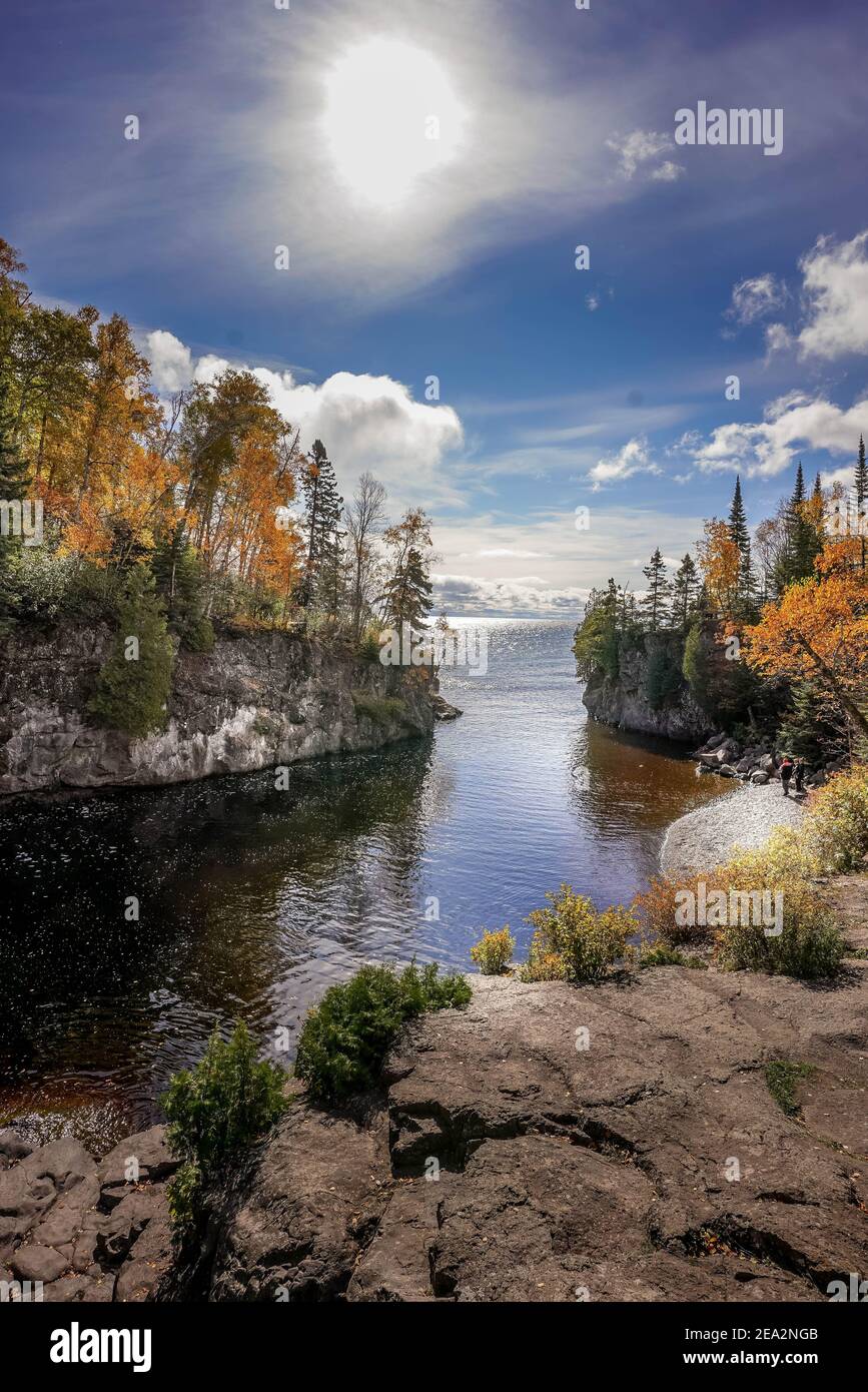 Sun shining over Baptism River where it meets Lake Superior at Tettegouche State Park, Minnesota Stock Photo