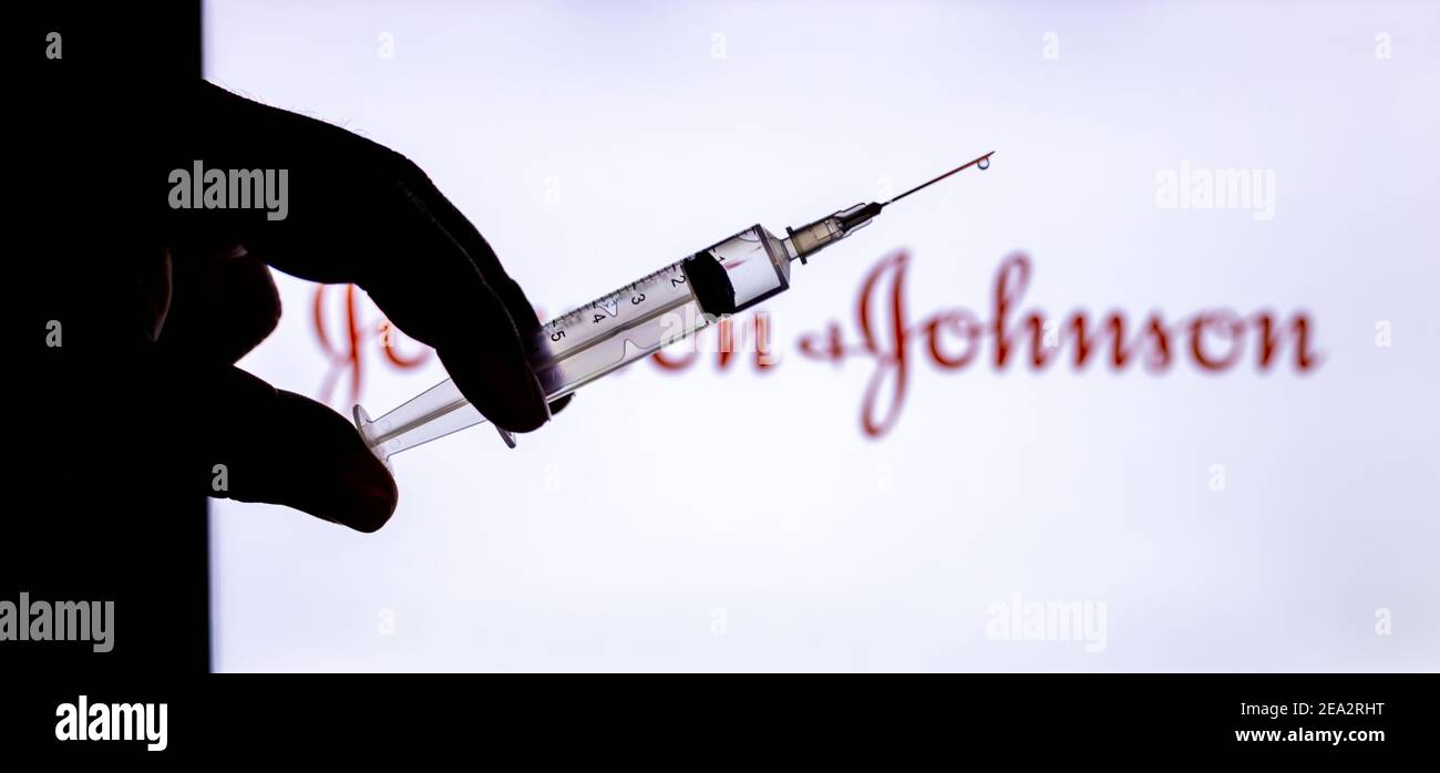 Kathmandu, Nepal - February 7 2021: Syringe Injection placed against Johnson and Johnson logo. JnJ coronavirus vaccine will work with only 1 dose as c Stock Photo