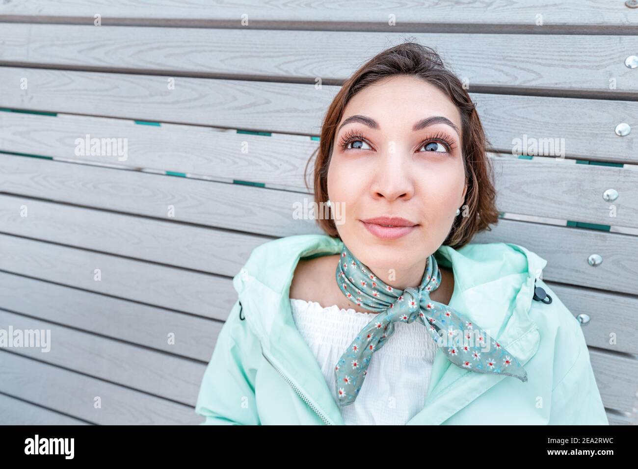 An Asian girl thinks while lying on a Park bench and dreams about her future. Middle Eastern or Asian appearance Stock Photo