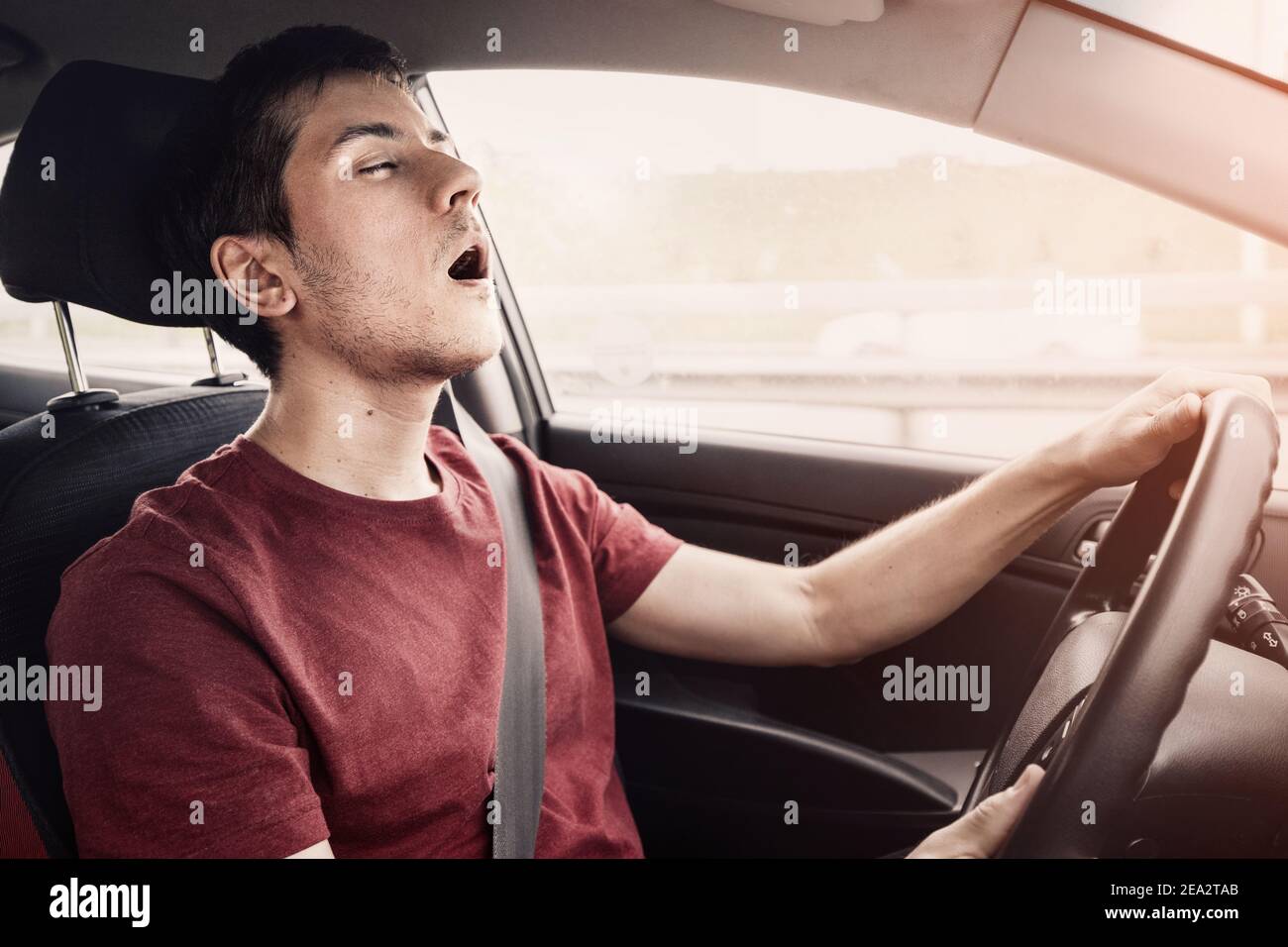 man driving the car fell asleep and does not control the road situation. Drugged with alcohol or insomnia concept. Car crashes and deaths Stock Photo