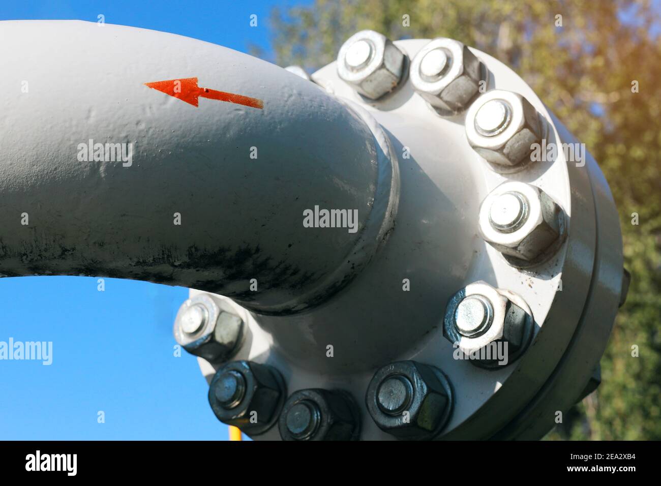 The red arrow on the gray pipe indicates the direction of the gas flow.  Stock Photo