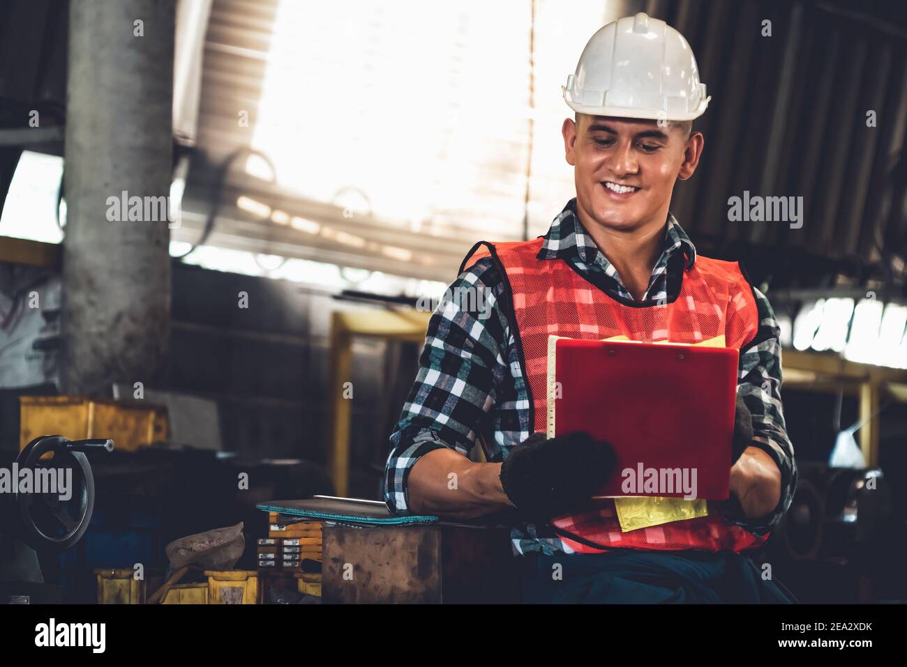 Manufacturing worker working with clipboard to do job procedure