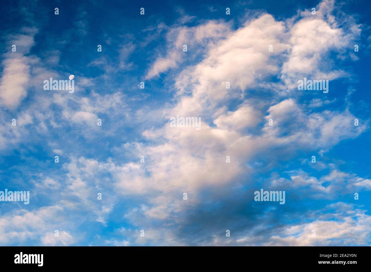 Cirrus Clouds with moon in morning light Stock Photo