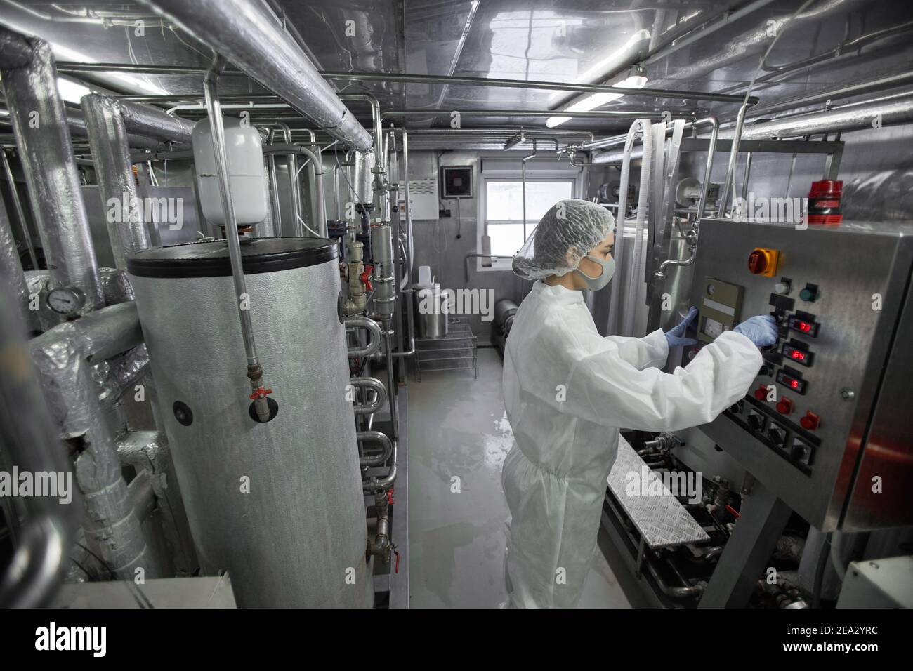 Food Factory Machine Operator Images High angle portrait of young female worker operating machine units at ...