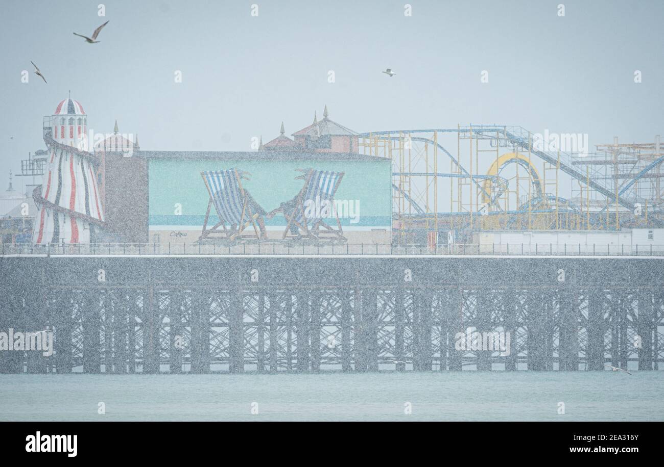 Snow falls over the closed Brighton Palace Pier in Brighton, Sunday Feb 9, 2021 Stock Photo