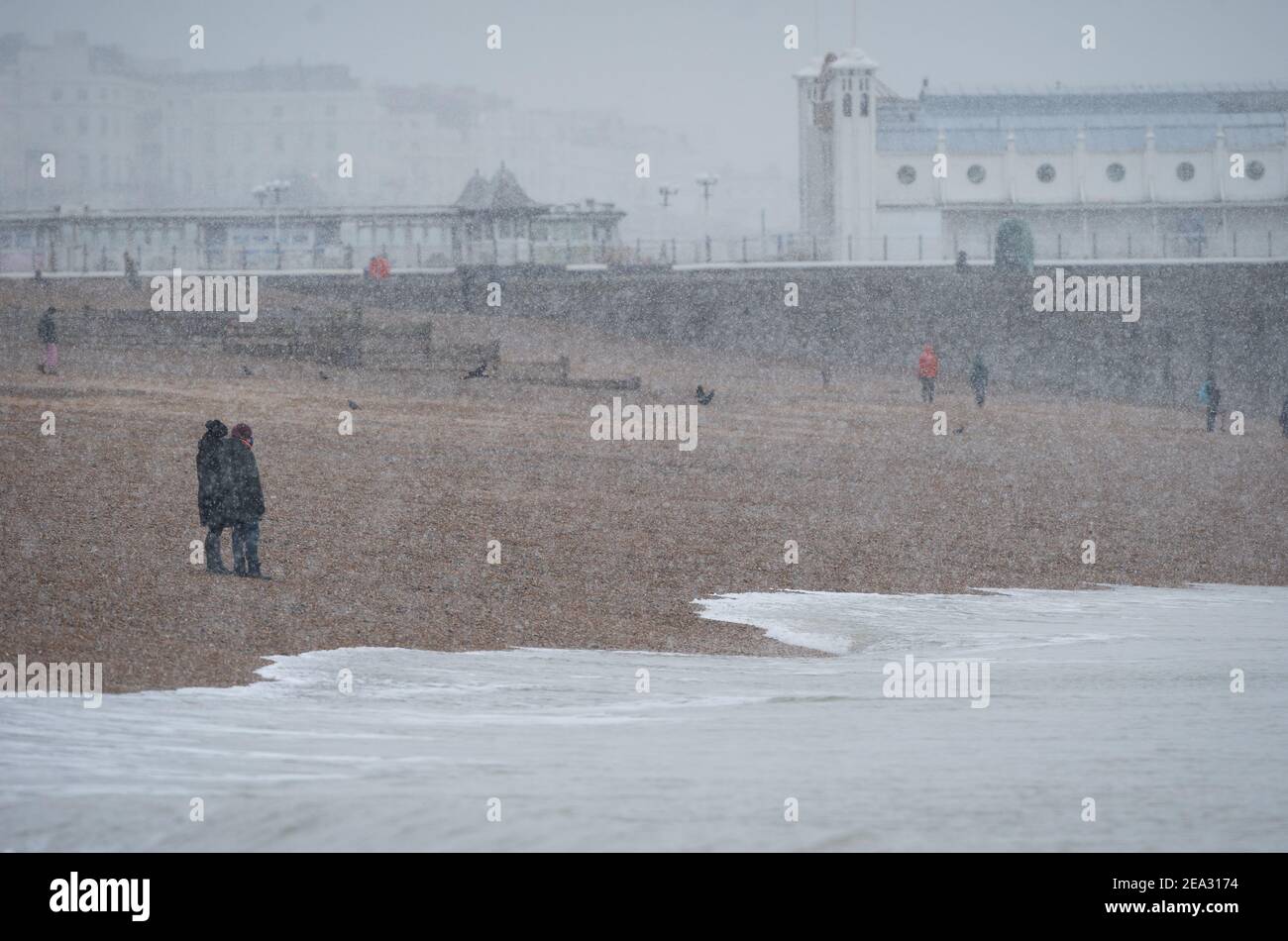 Snow falls on Brighton Beach by Brighton Palace Pier in Brighton, Sunday Feb 9, 2021 Stock Photo