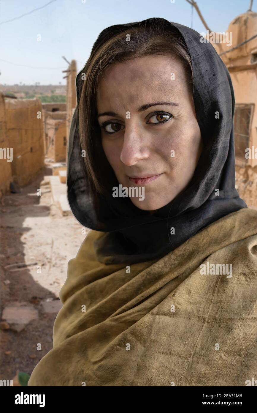 Portrait of woman with hijab and village ruins in the background Stock Photo