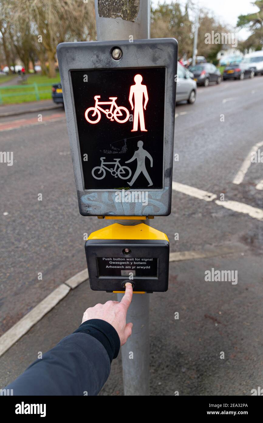 Cardiff, Wales - February 3rd 2021: A pedestrian presses the button, at a pedestrian crossing Stock Photo