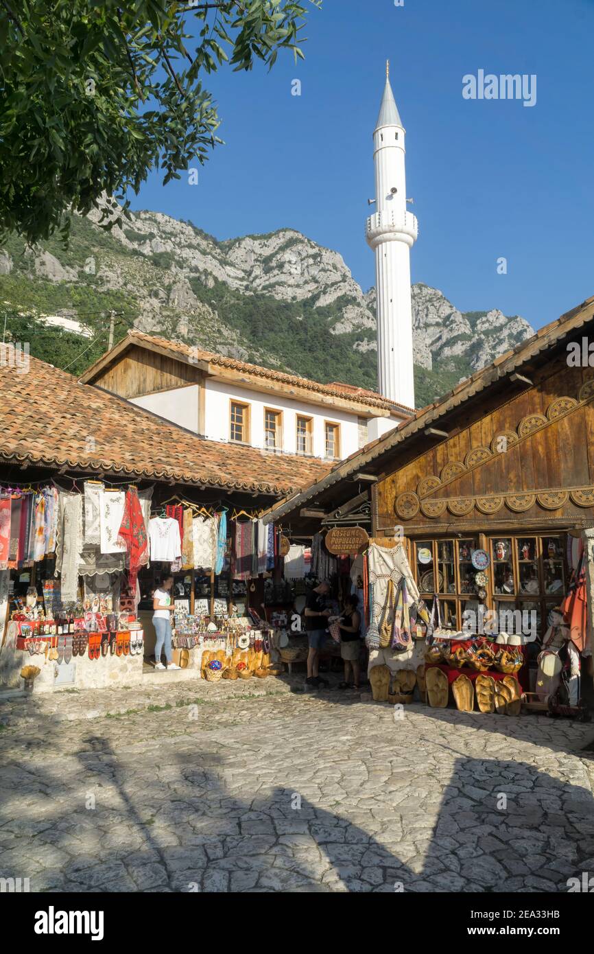 KRUJA, ALBANIA - SEPTEMBER 16, 2019:  street market with souvenirs, craft items and small shops in Kruja (Kruje) Albania, Europe. Minaret, mountain an Stock Photo