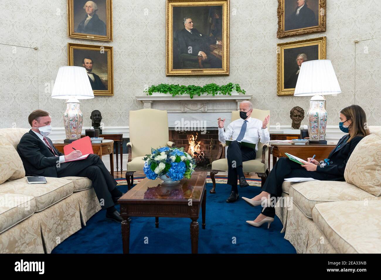 U.S President Joe Biden talks with National Security Adviser Jake Sullivan and Senior Director for Europe Amanda Slaot, prior to a phone call with German Chancellor Angela Merkel, in the Oval Office of the White House January 25, 2021 in Washington, D.C. Stock Photo